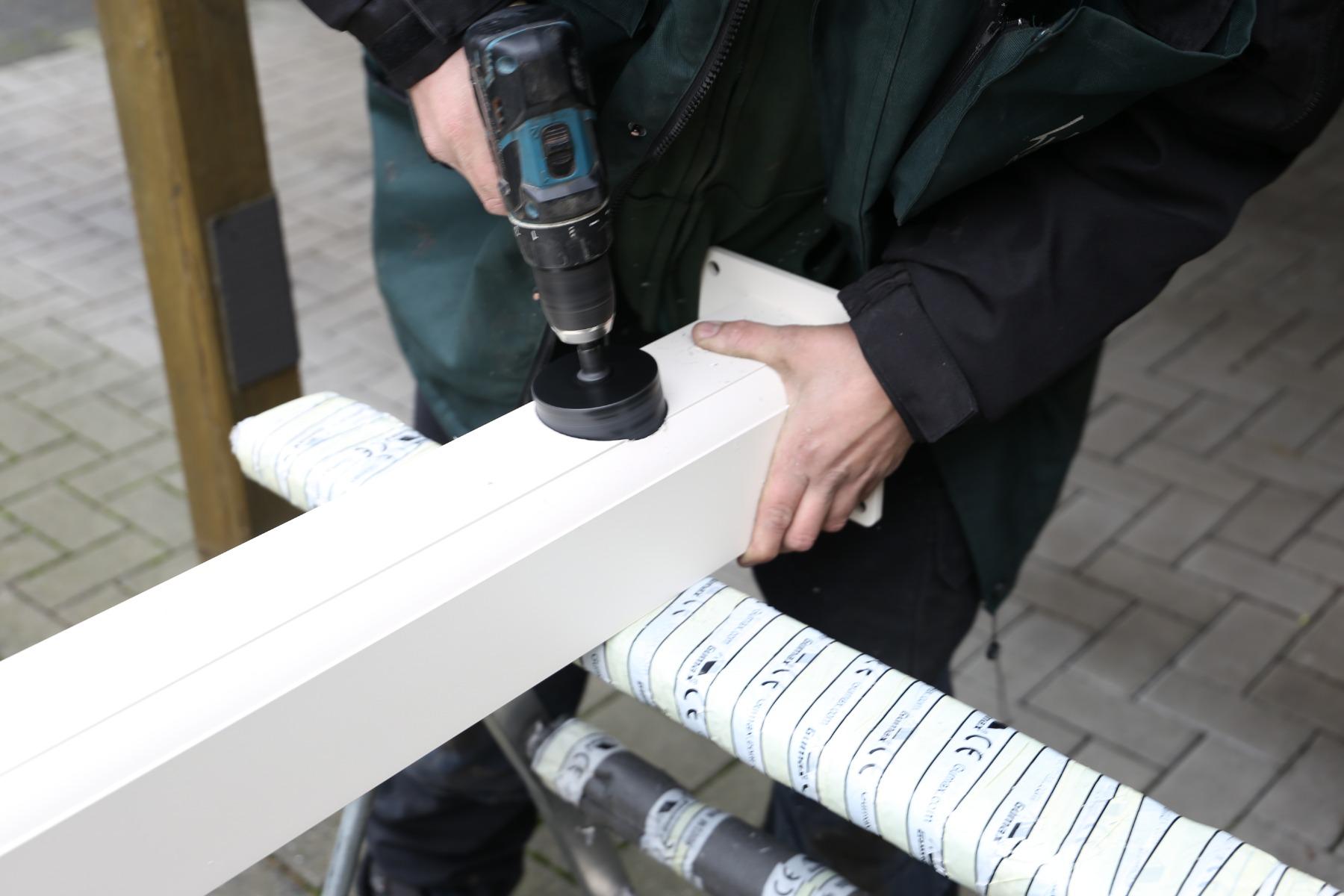 Hole is drilled for a downspout