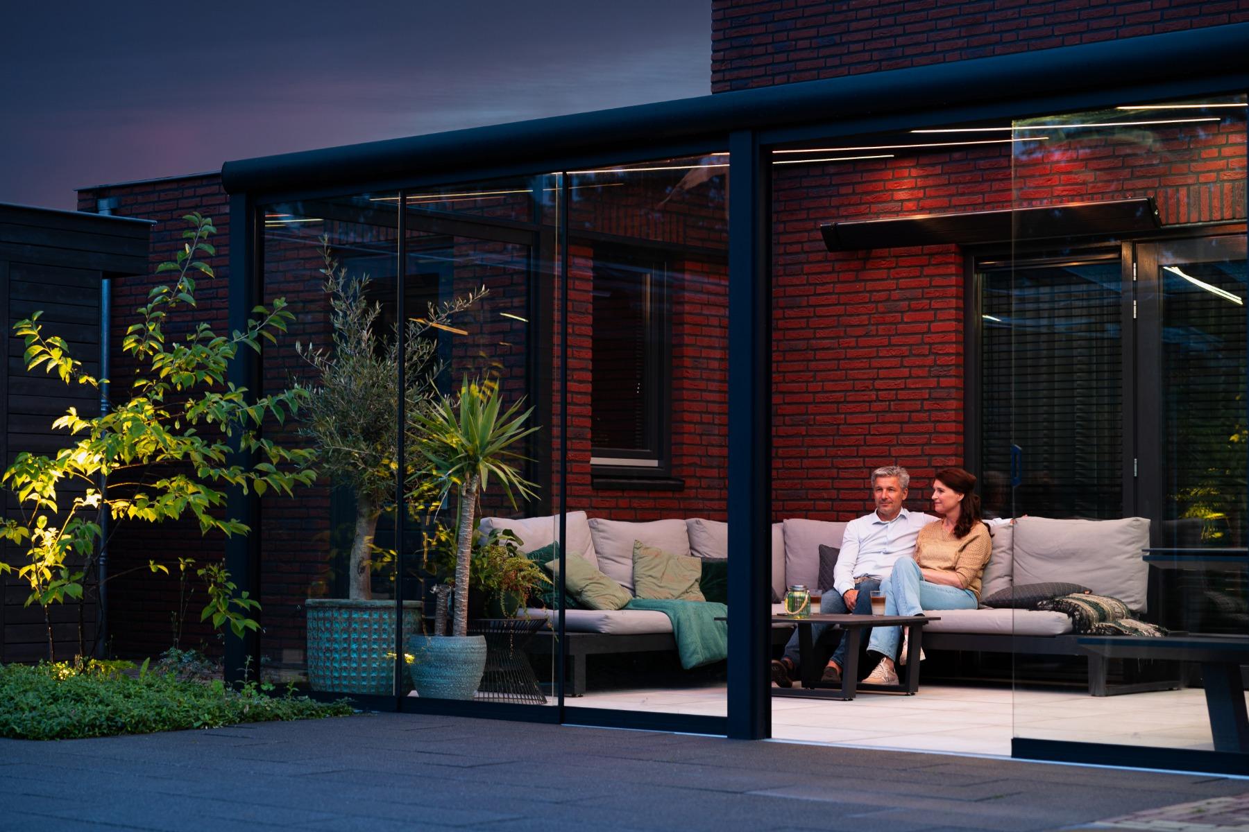 Matt black veranda with Gumax® Lighting System and glass sliding doors