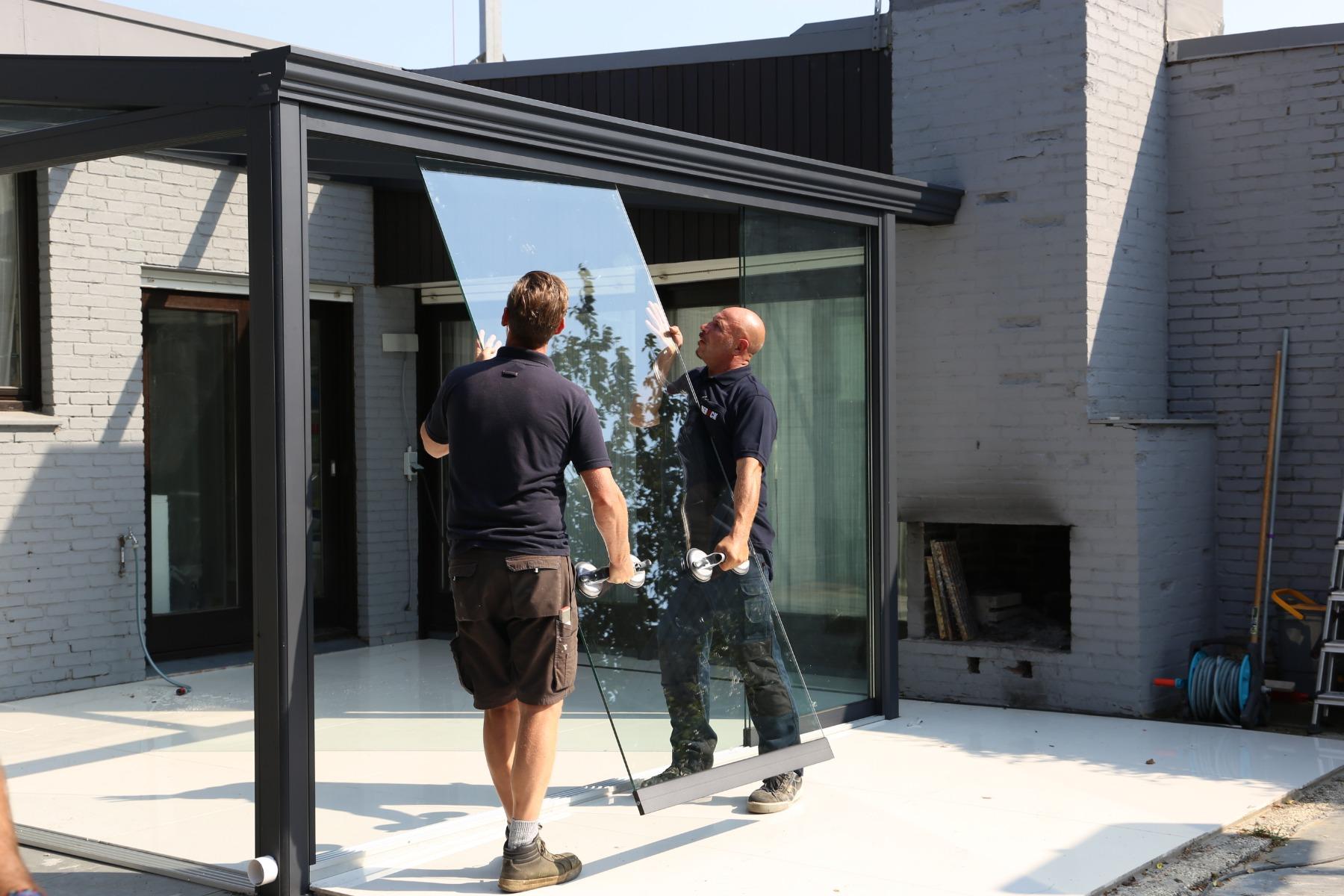 Preparing and installing glass panels of a sliding glass wall