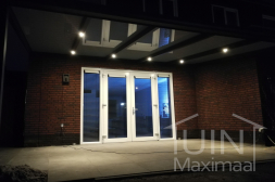 Gumax® LED lighting under anthracite-coloured pergola with glass roof