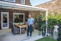 Glass sliding door with handles in white veranda